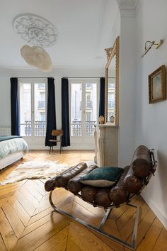 a bedroom with wooden floors and white walls