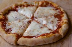 a close up of a pizza on a wooden table