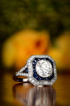 A gorgeous diamond and sapphire engagement ring. Art Deco style design with an antique old European cut diamond in the center. Antique Wedding Jewelry, European Cut Diamond Engagement Ring, Rings Sapphire, European Cut Diamond Ring, Estate Diamond Jewelry, Elegant Rings, Dream List, Antique Engagement Ring, Colored Engagement Rings