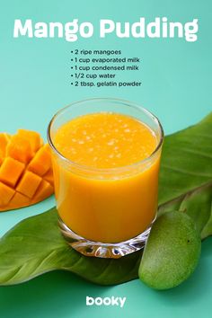 mango pudding in a glass on top of a green leaf next to sliced mangos