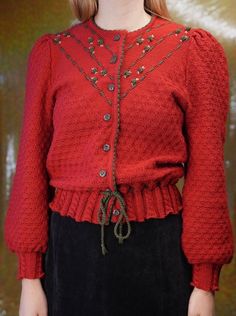 Stunning Austrian cardigan in red, partly knitted and partly crochet. Puffy sleeves, waistband and cute flower embroidery.  In very good condition. No holes, stains or other damages.  60% polyacrylic 40% wool Size 42 (Italian Size M). The model is 175cm tall, usually also wearing a size M. Shoulders: 39 cm ~ 15.35 inches Chest: 46 cm ~ 18.11 inches Sleeve: 67 cm ~ 26.38 inches Length: 60 cm ~ 23.62 inches ... Discount for multiple items, applies automatically at check-out: 3 or 4 items: 15% Off Embroidered Red Cardigan For Fall, Red Embroidered Fall Cardigan, Red Embroidered Long Sleeve Cardigan, Vintage Red Knitted Tops, Red Embroidered Winter Cardigan, Red Vintage Knit Cardigan, Vintage Red Knit Cardigan, Crochet Puffy Sleeves, Embroider Jacket