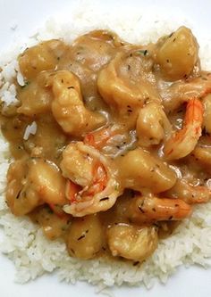 a white plate topped with rice covered in chicken and sauce