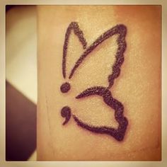 a small tattoo with a butterfly on it