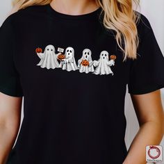 Spooky Ghosts Pumpkin Parade Halloween T-Shirt/Sweatshirt/Hoodie  Get into the Halloween spirit with our Spooky Ghosts Pumpkin Parade graphic! This festive design features four adorable yet eerie ghosts carrying pumpkins, perfect for adding a touch of spooky fun to your wardrobe. Available in a T-shirt, sweatshirt, or hoodie, it's ideal for Halloween parties, trick-or-treating, or cozy nights in. Made from high-quality, soft fabric, this apparel ensures comfort while you celebrate the season. Embrace the spooky season in style and let these charming ghosts lead the way to Halloween fun! 🎃 Details: Available in T-shirt, sweatshirt, and hoodie styles High-quality print featuring four spooky ghosts with pumpkins Soft, comfortable fabric for all-day wear Perfect for Halloween celebrations and Fall Hooded Graphic Print T-shirt, Hooded Graphic Print T-shirt For Fall, Spooky Black Crew Neck Hoodie, Black Spooky Crew Neck Hoodie, Halloween Cartoon Print Hooded Top, Hooded Halloween Tops With Cartoon Print, Hooded Halloween Cartoon Print Tops, Halloween Crew Neck Hoodie With Cartoon Print, Halloween Hoodie With Cartoon Print And Crew Neck