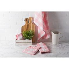 towels, potted plant and cutting board on counter