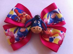 You are looking at a Winnie the Pooh and friends hair bow. There are two layers of grosgrain ribbon. The top ribbon layer has Pooh, Tigger, Eeyore, and Piglet allover. The under layer is in a solid hot pink ribbon. The French barrette is trimmed in a matching hot pink ribbon. There is a decorative Eeyore flat back on the front. The bow is approximately 4" wide and 2 3/4" from top to bottom at the tallest part. This is a handmade item. Free shipping within the US and we also offer priority mail s Minnie Mouse Ribbon, Hot Pink Ribbon, Minnie Mouse Hair Bows, Hair Bows Diy Ribbon, Disney Hair Bows, Winnie The Pooh And Friends, Pooh And Friends, Disney Hair, Girls Hair Bow