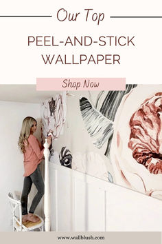 a woman painting a wall with the words our top peel and stick wallpaper