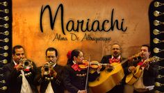 a group of men playing musical instruments in front of a sign that says mariachi