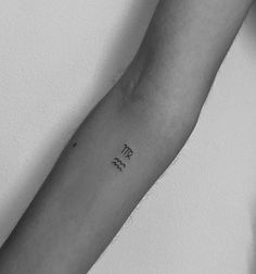 a black and white photo of a person's arm with the word love tattooed on it