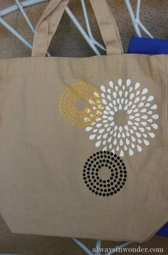 a brown bag with white and yellow designs on it sitting on the floor next to a chair