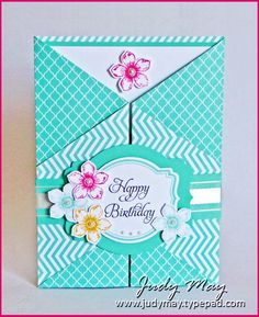 a blue and white birthday card with pink flowers on the front, and an envelope that says happy birthday