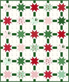 a christmas quilt with red, green and white stars on the center is featured in this image