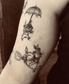 a person with a tattoo on their arm holding an umbrella