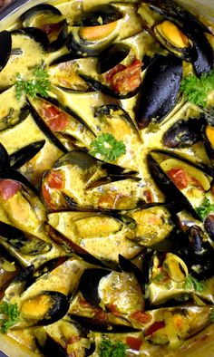 a large pot filled with mussels and sauce