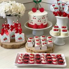 a table topped with cakes and cupcakes covered in frosting