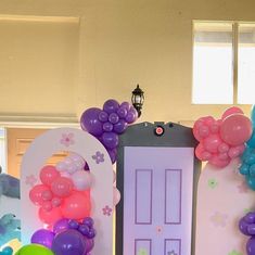 the balloons are all over the room and there is a door with flowers on it