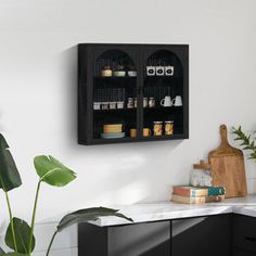 a kitchen with black cabinets and white walls