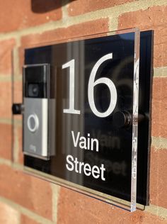 a close up of a brick wall with a sign on it that says 16 vain street