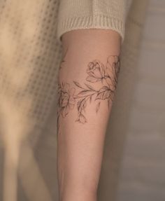 a person with a flower tattoo on their arm