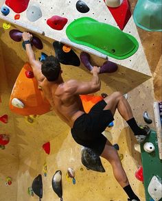 a man climbing up the side of a rock wall