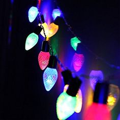 multicolored christmas lights are hanging in the dark