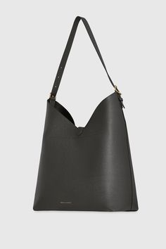 The Megan Hobo is the ideal go-to bag for those seeking effortless style and functionality. Crafted from genuine leather, this spacious hobo is designed to fit all your essentials while maintaining a sleek and modern silhouette. Its magnetic snap closure and antique brass hardware add a touch of sophistication, making it a perfect choice for everyday wear. Style # HH24HMGHOB-SHADOW 100% Genuine Leather Multi Hardware 13" W X 14. 5" H X 6. 25" D 23" Strap Drop Magnetic Snap Closure 1 Back Zip Poc Modern Hobo Bag With Leather Handles For Errands, Modern Soft Leather Hobo Bag For Errands, Modern Hobo Bag With Removable Pouch For Errands, Modern Hobo Bag With Adjustable Strap For Errands, Modern Bucket Bag With Removable Pouch For Errands, Modern Hobo Satchel Bag For Errands, Classic Hobo Bag With Removable Pouch For Errands, Leather Outerwear, Antique Brass Hardware