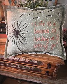 a decorative pillow that reads, life is a balance of holding on to letting go