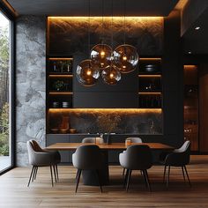 a modern dining room with black walls and wooden flooring is lit by pendant lights