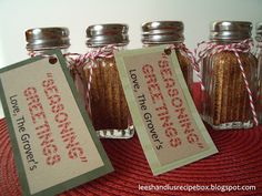 three glass jars filled with cinnamon sticks and two tags attached to the top of them