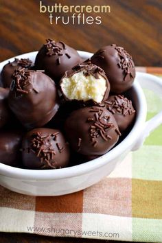 chocolate covered truffles in a white bowl on a checkered tablecloth with the words buttercream truffles