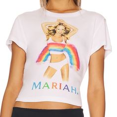 a woman wearing a white crop top with a rainbow graphic on the front and bottom