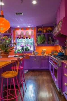 an orange and purple kitchen with wooden floors