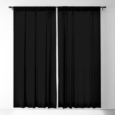 a black curtain hanging on the side of a wall