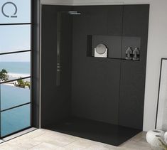 a bathroom with a walk in shower sitting next to a large glass door that leads out to the ocean