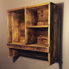 a wooden shelf mounted to the side of a wall