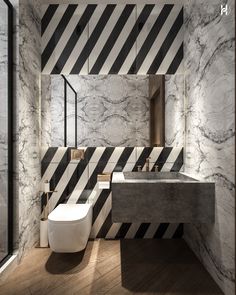 a modern bathroom with black and white stripes on the walls, wood flooring and marble countertops