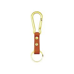 a caramel colored keychain with two gold circles on the front and back