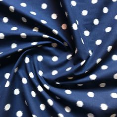 the fabric has white dots on it and is very dark blue with white polkas