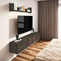 there is a tv on the wall in this living room with wood flooring and white walls