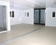 an empty room with white walls and doors