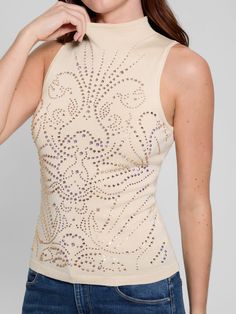 Knit sweater top Rhinestone detailing throughout Turtle neckline Sleeveless silhouette Slips on 71% ECOVERO™ Viscose, 29% Polyamide/Nylon. Contains renewable, wood-based fibers. Hand wash Sleeveless Stretch Tops With Rhinestones, Chic Sleeveless Tops With Rhinestones, Stretch Sleeveless Top With Rhinestones, Chic Embellished Stretch Tank Top, Elegant Fitted Rhinestone Tank Top, Stretch Sleeveless Rhinestone Top, Fitted Beige Jacquard Knit Top, Luxury Cream Jacquard Knit Top, Beige Stretch Knit Top With V-neck