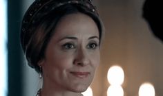 a woman in a tiara looking at the camera