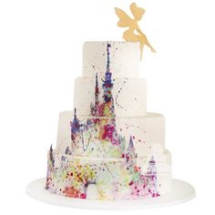 a multi - tiered cake decorated with watercolors and a fairy tale figure