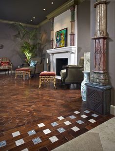 a living room filled with furniture and a fire place in the middle of a room