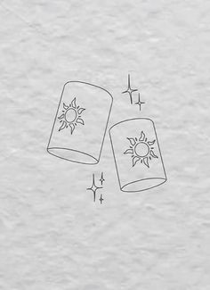 two jars with the sun and stars drawn on them, one is upside down in front of the other