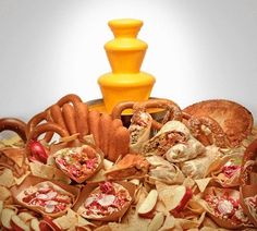 an assortment of food is displayed on a platter with a yellow vase in the background