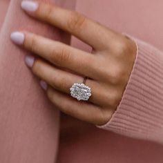 a woman's hand with a diamond ring on it