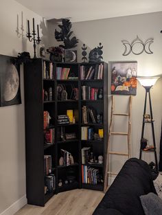 a living room filled with lots of books and furniture