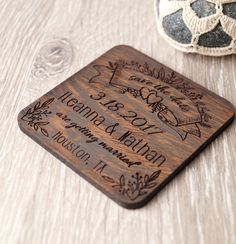 a wooden coaster with the names and date engraved on it