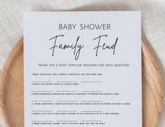 a baby shower game is shown on a wooden plate with a white sheet that says, baby shower family fund